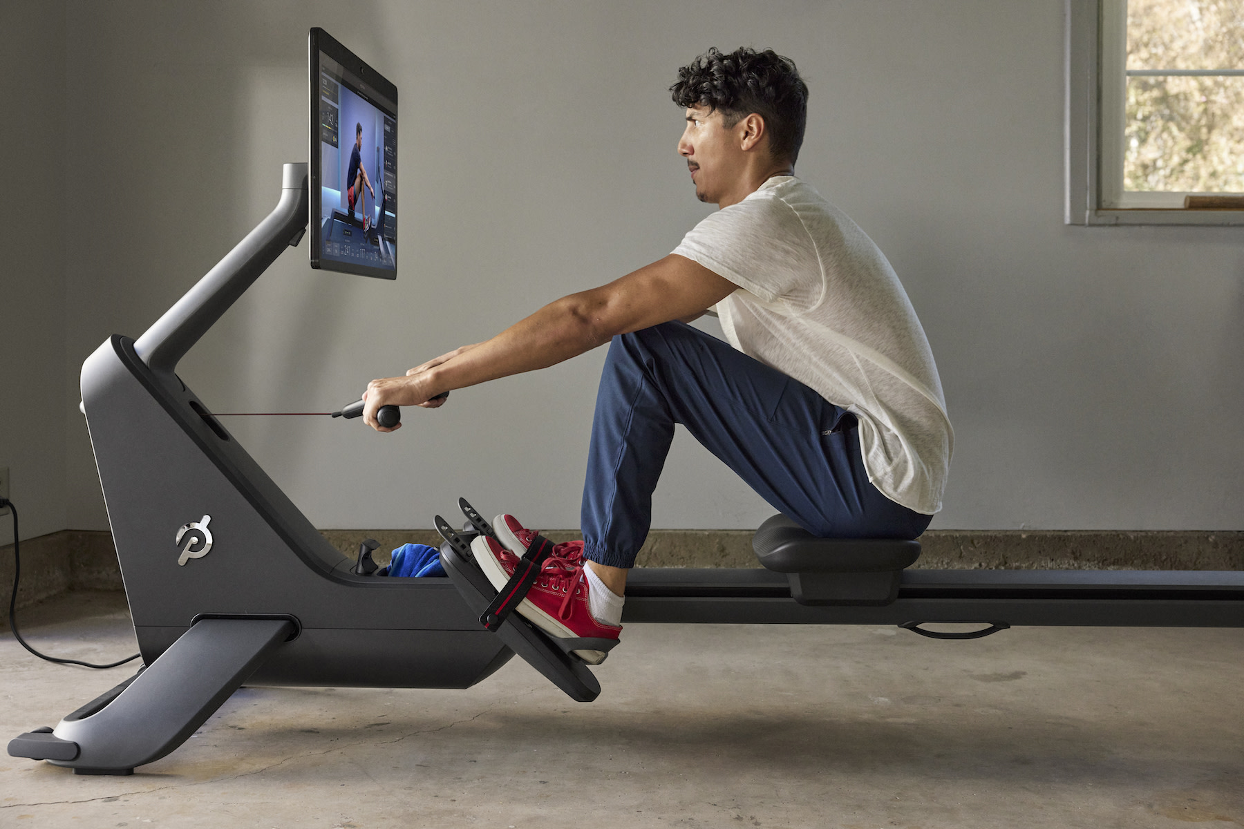 Man does a full-body workout on a rowing machine
