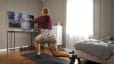 Woman works out at home with Peloton Guide
