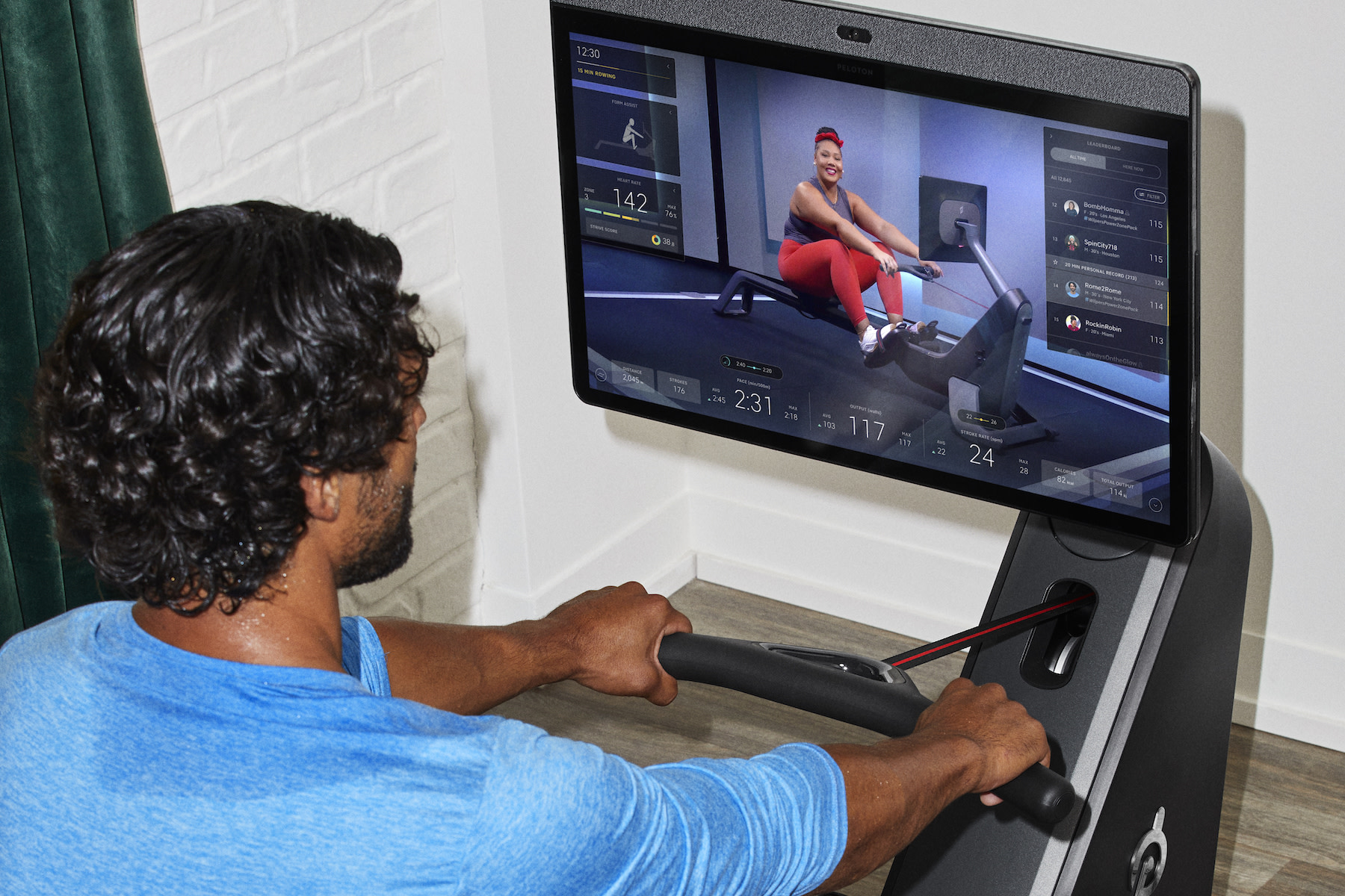 Man does rowing workout on Peloton Row 