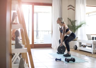 Woman does weight training workout at home