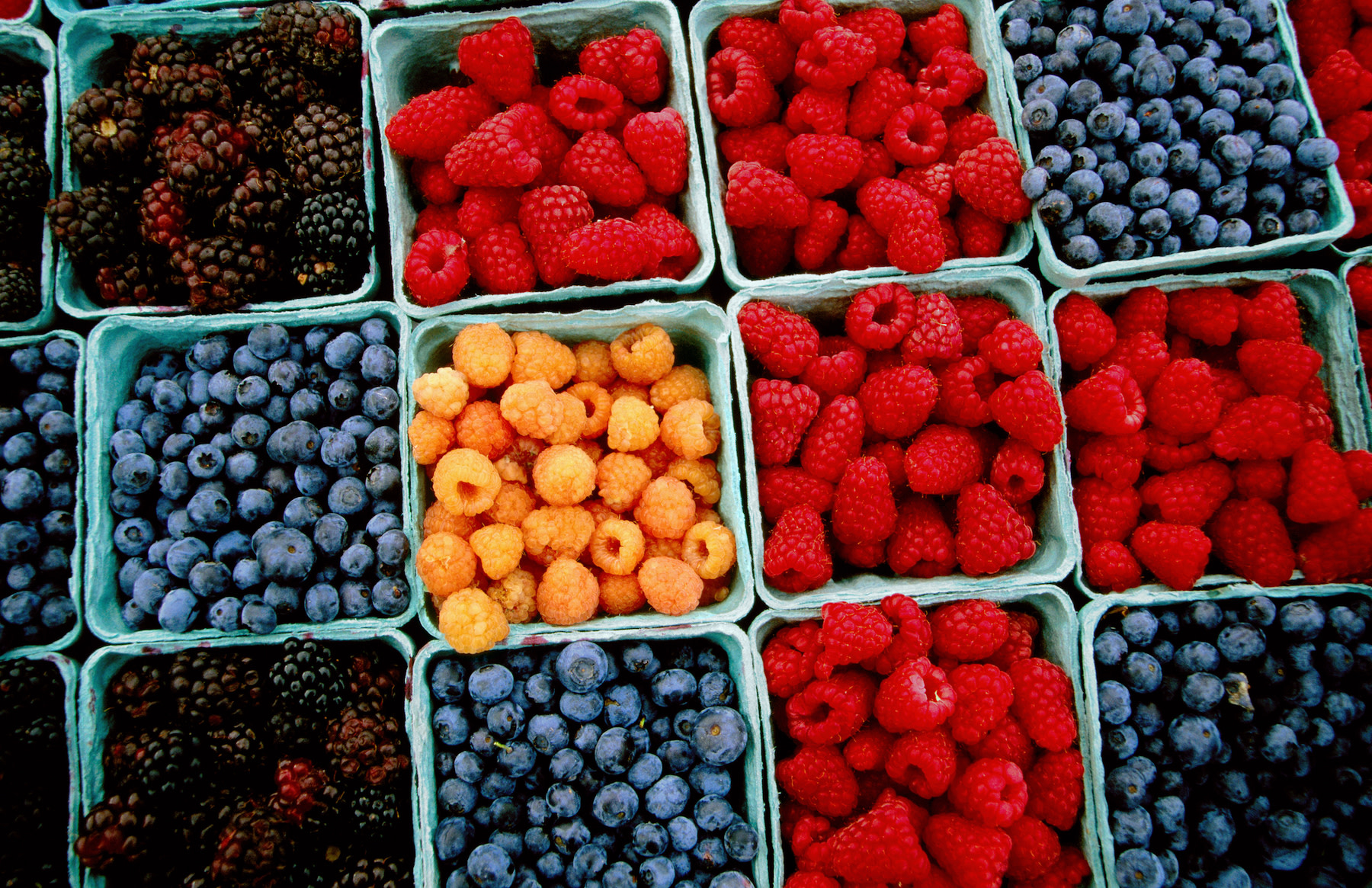 High-Fiber Foods: Multiple cartons of raspberries, blueberries, and blackberries.