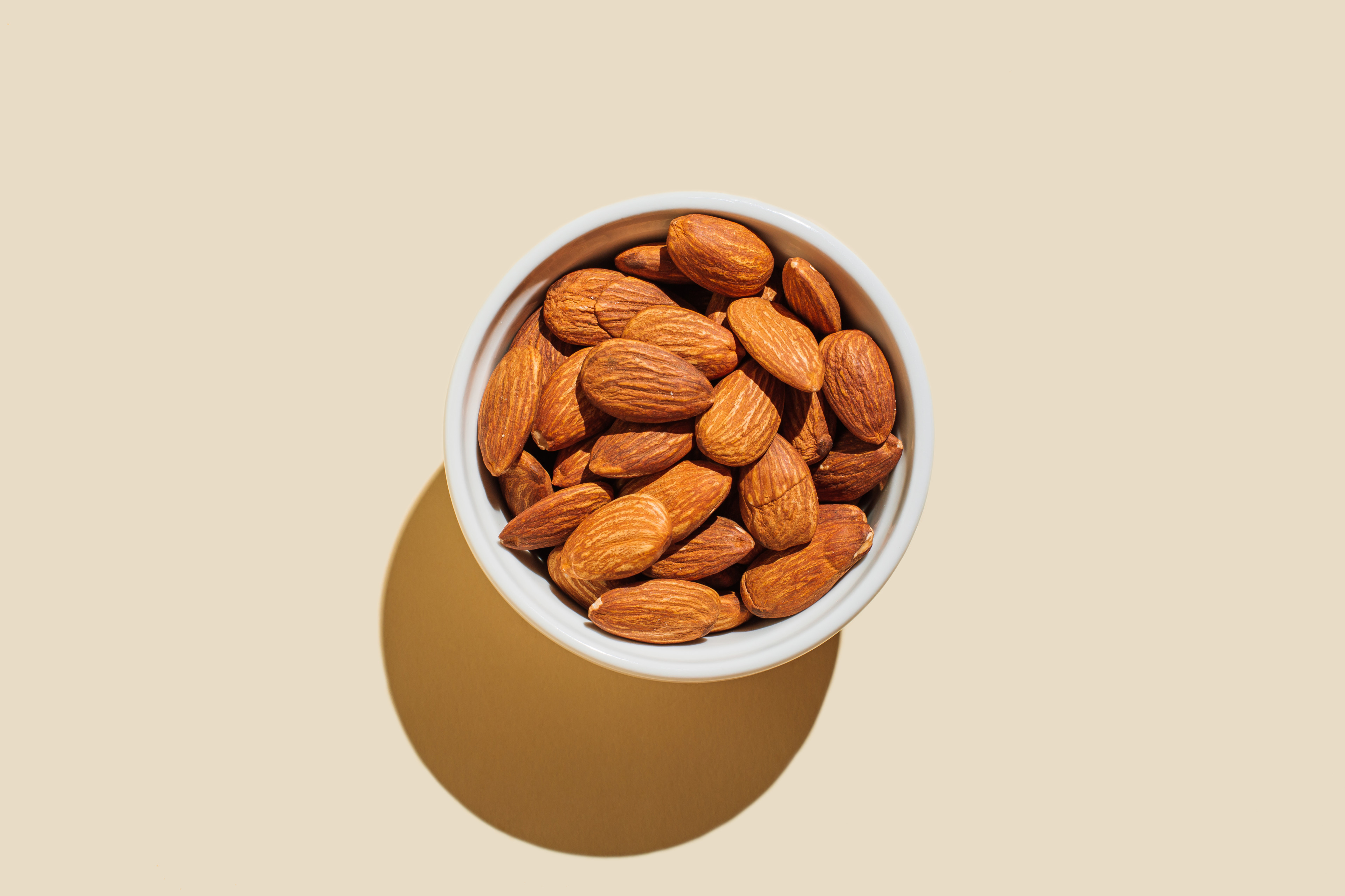 High-Fiber Foods: A bowl of almonds against a neutral background.