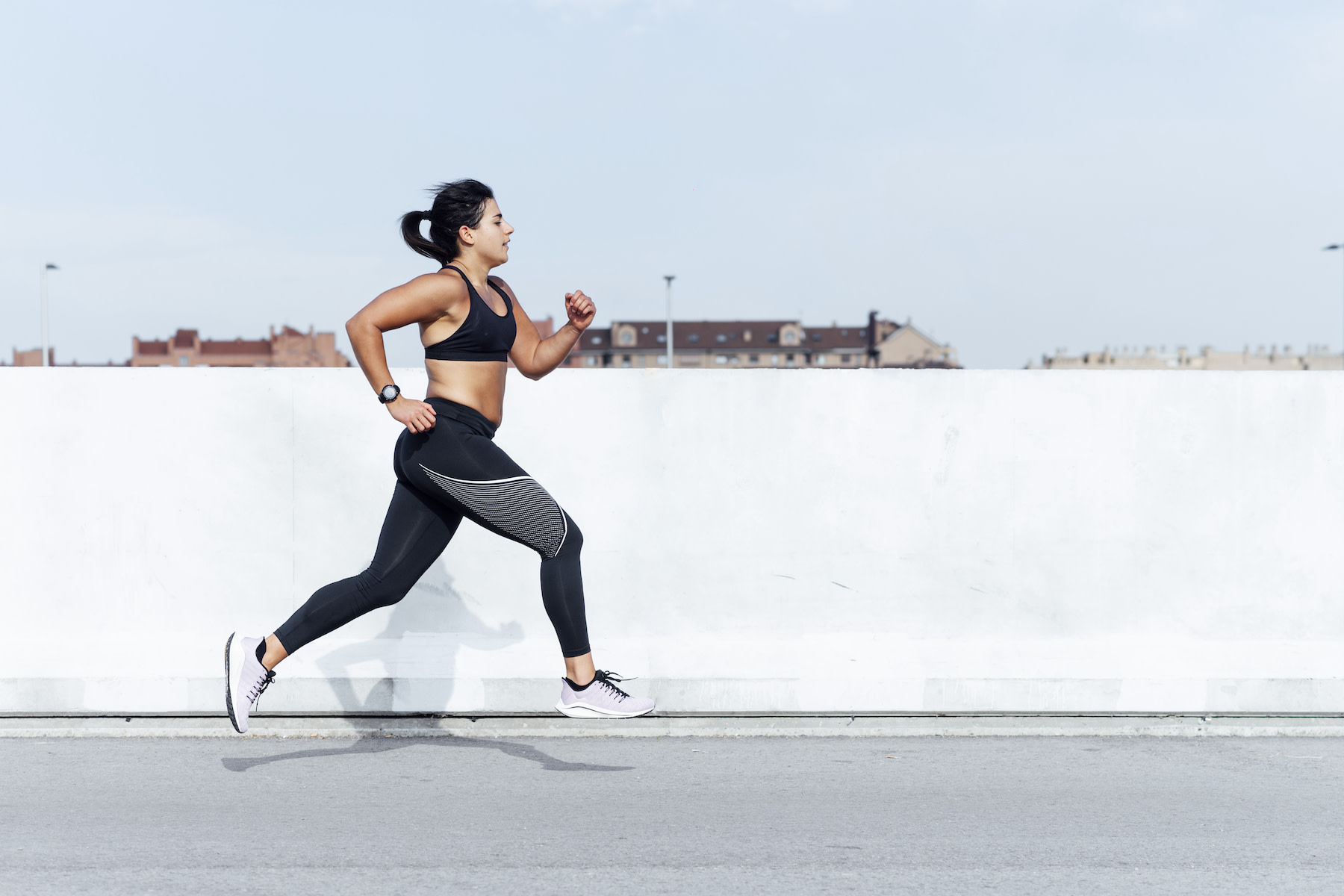 Woman does sprints outside while doing interval training