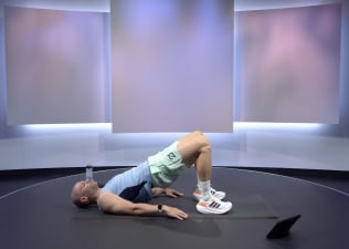 Man demonstrates how to do a glute bridge