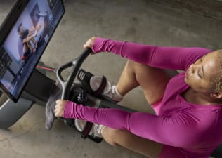 woman warming up on rowing machine