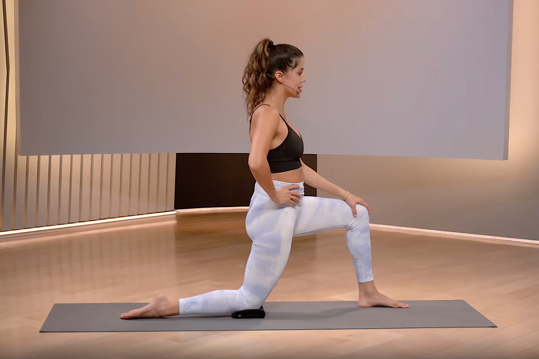 Woman does kneeling hip-flexor stretch